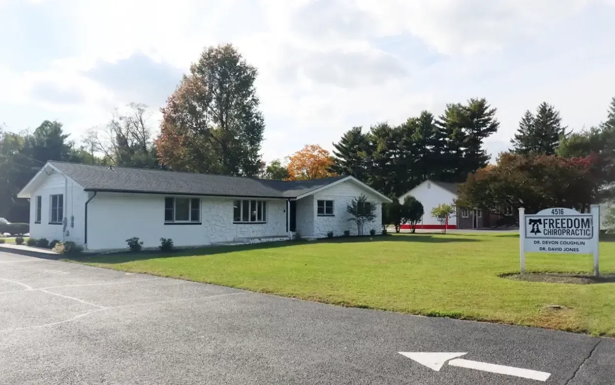 The Freedom Chiropractic office on Church Road East, a white single-story building with the practice sign on the front lawn.