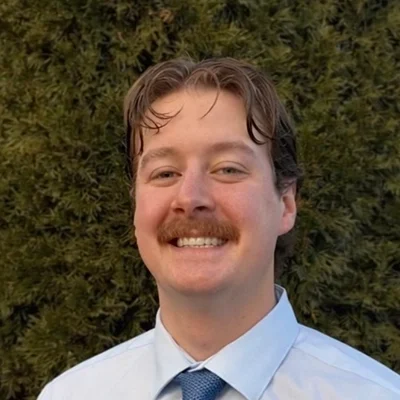 Cameron Pettit smiling outside.